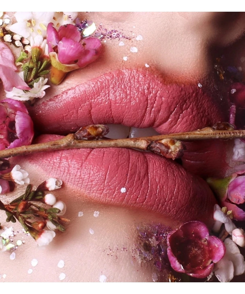Suzy Lipsticks Miss Cassandra Peony matte lipstick, showing the deep pink shade in a sleek tube on a neutral background.