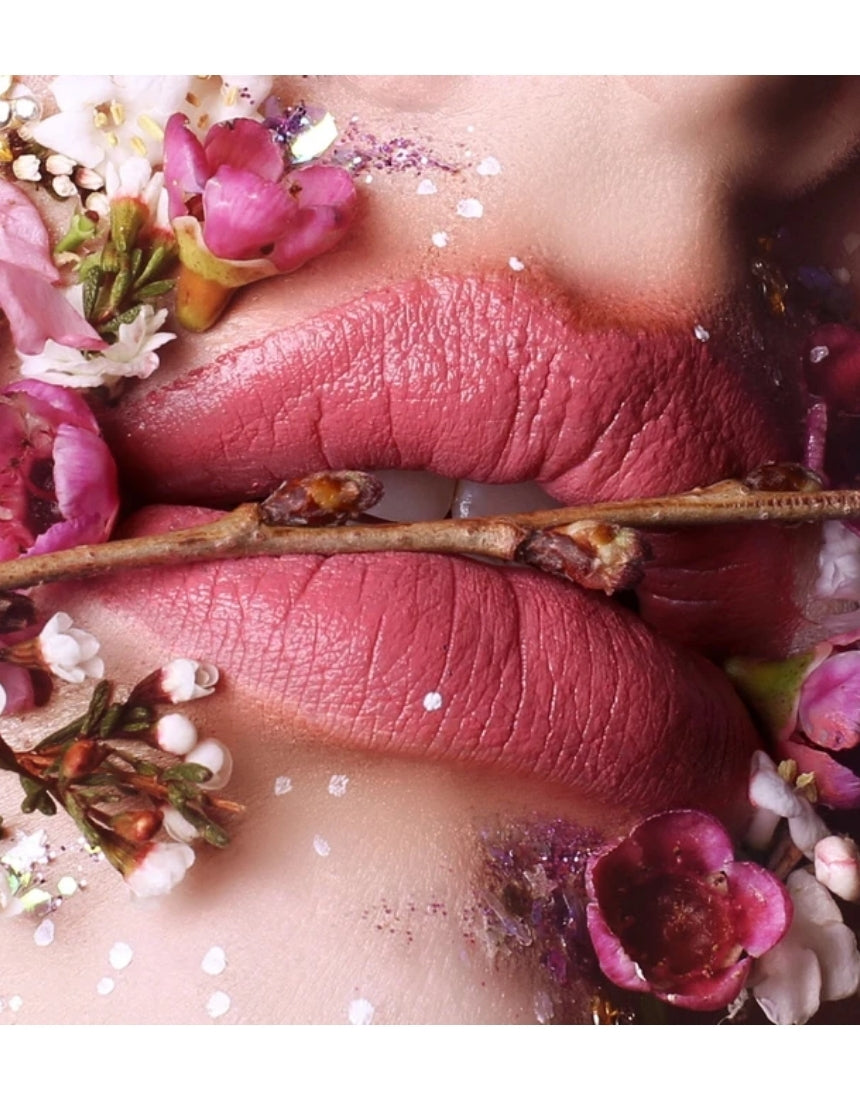 Suzy Lipsticks Miss Cassandra Peony matte lipstick, showing the deep pink shade in a sleek tube on a neutral background.